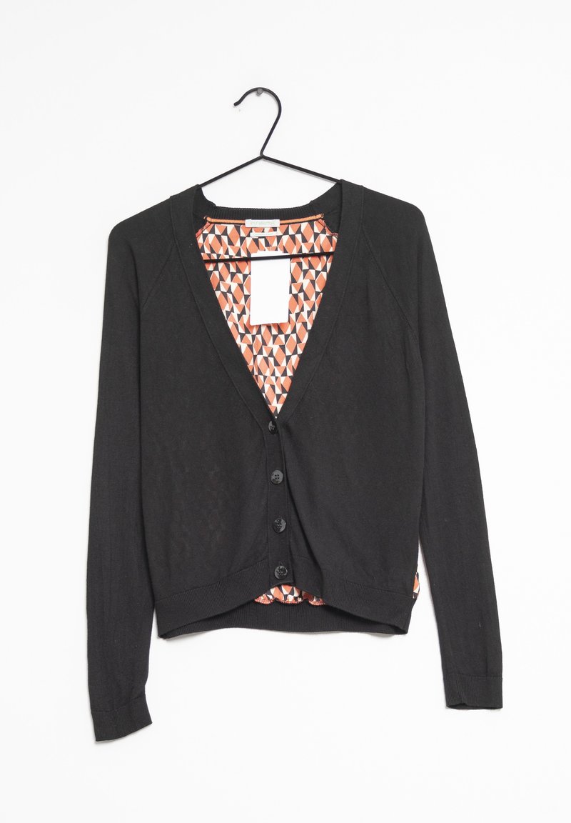 Svart cardigan med v-ringning, långa ärmar och knappstängning. Insidan har ett geometriskt mönster i orange och vitt.
