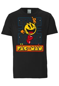 Black cotton T-shirt featuring a colorful Pac-Man graphic with a yellow character, red shoes, and orange text below, set against a maze backdrop.