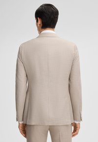 Hellbeige Anzugjacke mit strukturiertem Muster, einzelnem Rückenschlitz und Drei-Knopf-Manschetten. Maßgeschneiderte Passform mit glatter Oberfläche.