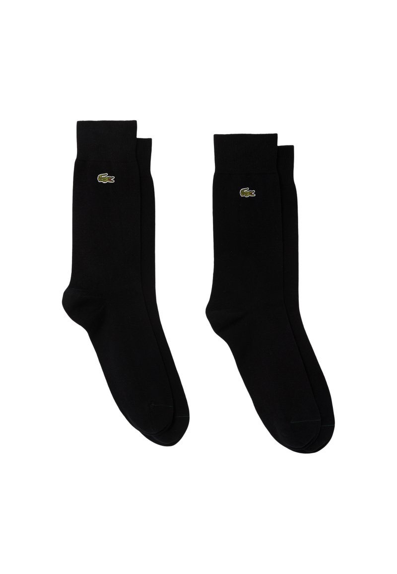 Calzini neri in cotone con polsini a coste e logo verde Lacoste sul lato esterno, caratterizzati da una superficie liscia e una lunghezza standard da crew.