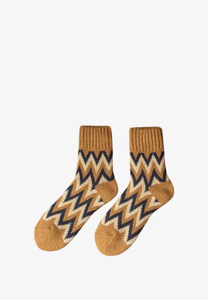 Socken mit Zickzackmuster in Beige und Navy, mit gerippten Bündchen und weicher Textur, versehen mit kontrastierenden beigen Akzenten an Zehen und Fersen.