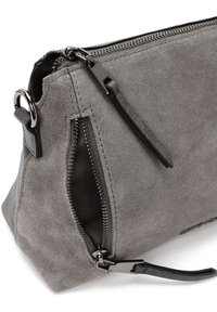 Gray suede bag with a zippered closure, featuring a side pocket and a leather strap. Matte finish with contrasting hardware accents.