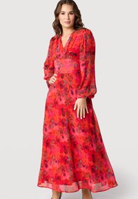 Rode bloemen maxi-jurk met lange pofmouwen, V-hals en een gedefinieerde taille. Lichtgewicht, vloeiende stof met een levendig bloemenpatroon.