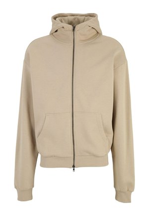 Beige zip-up hoodie with a hood, large front pockets, and ribbed cuffs and hem. Soft fabric with a smooth texture. Simple design.