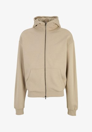 Sweat à capuche zippé beige avec une capuche, de grandes poches avant et des poignets et un ourlet côtelés. Tissu doux avec une texture lisse. Design simple.