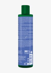Zielona plastikowa butelka nawilżającego szamponu o zakrzywionym kształcie, z niebieskim napisem i zabezpieczoną zakrętką na flip-top. Zawiera naturalne składniki.