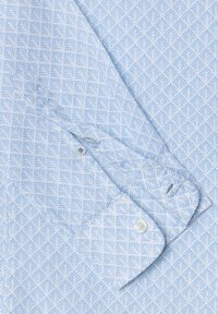 Light blue and white patterned long-sleeve shirt cuff with white buttons, folded over on matching fabric background.