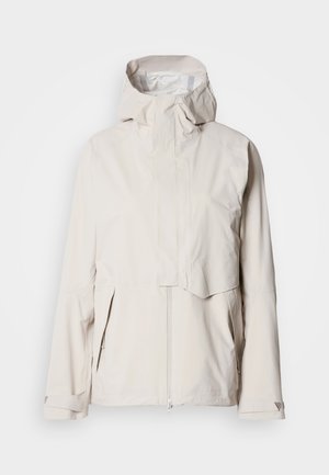 Ελαφρύ μπεζ μπουφάν με ψηλό γιακά, κούμπωμα με φερμουάρ και δύο πλαϊνές τσέπες· διαθέτει ομαλή υφή και ρυθμιζόμενα μανίκια.