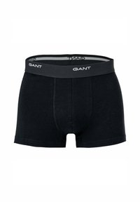 Black boxer shorts made of soft cotton with a gray elastic waistband featuring the "GANT" logo in white. Stitching detail along the seams.