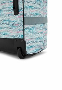 Rolling suitcase with a blue and pink palm leaf pattern, black base, and sturdy wheels. Features a gray strap and zipper for closure.
