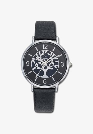 Montre ronde en argent avec un cadran noir présentant un design d'arbre. Bracelet en cuir noir, index horaires argentés et aiguilles simples pour indiquer l'heure.