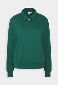 Pull vert à manches longues avec col à revers et courte fermeture éclair devant, fabriqué dans un tissu doux.