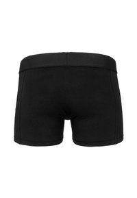 Zwarte katoenen boxershorts met een brede elastische tailleband, voorzien van een slanke pasvorm en een eenvoudig, naadloos ontwerp. Geen zichtbare patronen of accenten.