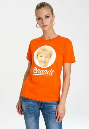 Orange cotton t-shirt featuring a circular graphic of a smiling child and the name "Brandt" in white cursive text beneath.