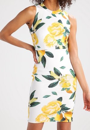 Valkoinen istuva mekko, jossa keltainen kukkakuosi ja vihreät lehdet; hihaton malli, pyöreä pääntie ja sileä pinta.