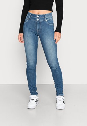 Jeans ajustados de denim azul desgastado, de cintura alta con un cierre de doble botón, cinco bolsillos y con un ligero estiramiento para mayor comodidad.