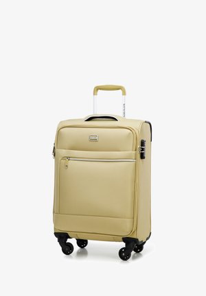 Tvrdý kufr v světle béžové barvě s texturovaným povrchem, dvojitým zipem, přední kapsou a čtyřmi černými kolečky pro snadnou manipulaci.