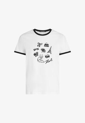 Witte katoen t-shirt met zwarte geribde kraag en mouwen; bevat verschillende zwarte schetsen, waaronder een kat, de Eiffeltoren en een zonnebril.