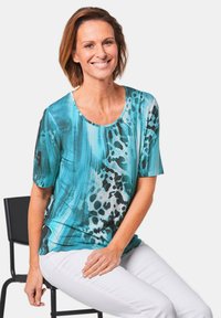 Korte mouwen top met een turquoise en zwart abstract patroon, gemaakt van een gladde stof, met een ronde halslijn en een ontspannen pasvorm.