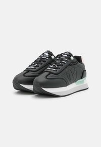 Black athletic shoes with a smooth leather upper, white midsole, mint green accents, and patterned black laces featuring brand text.