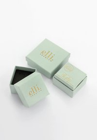 Light green premium jewelry boxes with gold "elli" logo, one open showing black interior, on a white surface.