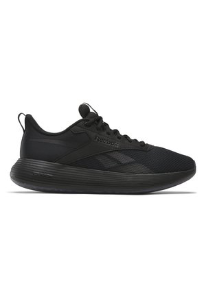 Zapatillas deportivas negras con parte superior de malla, punta redondeada, suela texturizada y diseño minimalista, con un acento de marca en el lateral.