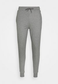 Grå sweatpants i mjuk tyg, med dragsko i midjan och avsmalnande ben med ribbade muddar vid anklarna.