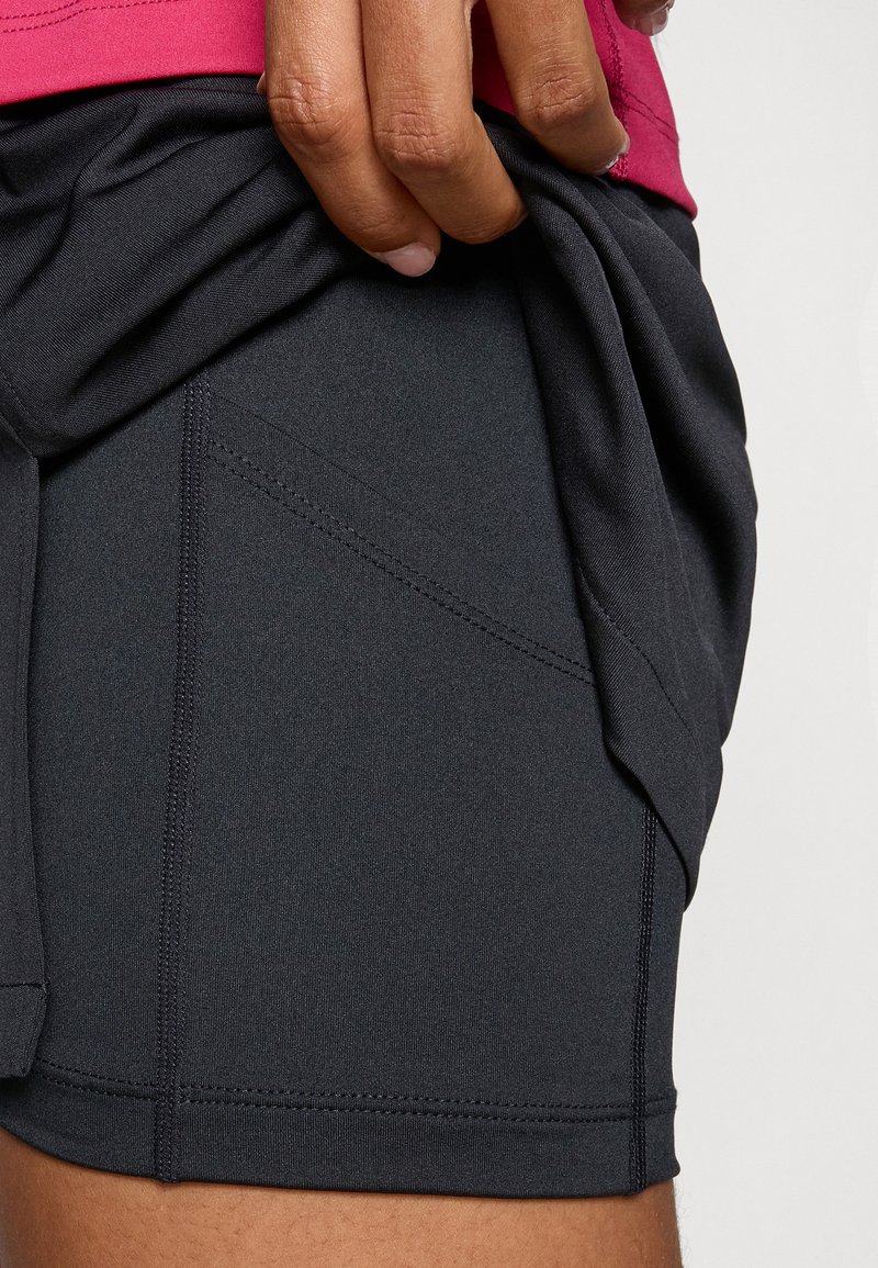 Pantalones cortos deportivos negros hechos de una tela ligera que absorbe la humedad. Presenta costuras planas y un diseño ajustado con un trasero ligeramente más largo.