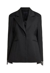 Blazer noir sur mesure avec un seul bouton, détails en dentelle sur les épaules et les poignets, et revers à pointe.