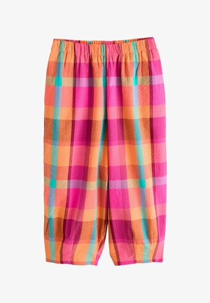 Løse bukser med elastisk linning, med et lyst ternet mønster i pink, orange, blågrønne og røde nuancer på et tekstureret stof.