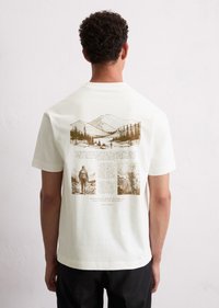 White cotton t-shirt featuring a brown graphic illustration of mountains, trees, and text on the back, with a crew neckline and short sleeves.