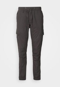 Pantalon décontracté gris foncé avec taille élastique, cordon de serrage, poches cargo latérales et poignets élastiques, conçu pour le confort et l'utilité.