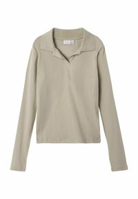 Ljust beige långärmad polo med ribbad textur, featuring en krage och en liten knappdetalj fram.