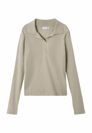 Ljust beige långärmad polo med ribbad textur, featuring en krage och en liten knappdetalj fram.