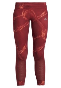 Czerwone legginsy sportowe z abstrakcyjnym pomarańczowym wzorem, wykonane z elastycznego materiału. Posiadają siateczkowe wstawki w okolicy kostek oraz szeroki pas w talii.