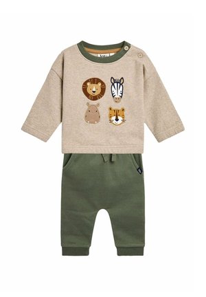 Camiseta de manga larga beige con aplicaciones de animales (león, cebra, hipopótamo, tigre) y puños verdes, combinada con pantalones de chándal verdes con bolsillos.