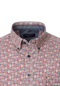 Casual fit shirt with a multi-colored dot pattern in red, blue, and yellow on a cream background. Features a button-down collar and dark buttons.