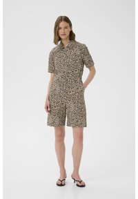 Short-sleeve jumpsuit with a leopard print pattern, featuring a button-up front, two side pockets, and a relaxed fit in beige and dark brown tones.