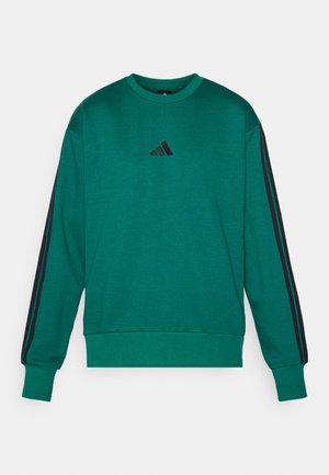 Grøn sweater lavet af bomuldsblanding, med rund halsudskæring, lange ærmer og sorte side-striber samt et lille sort logo på brystet.