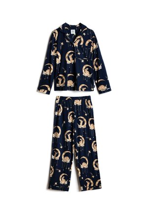 Haut de pyjama bleu marine avec des croissants de lune jaunes, des lapins tenant des étoiles et des décorations d'étoiles suspendues sur un tissu doux avec une poche poitrine.