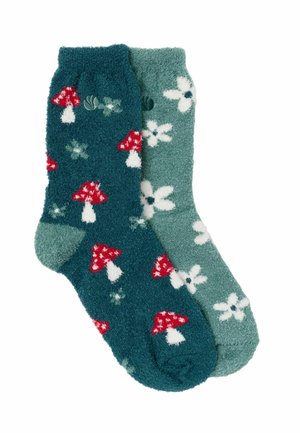 Zwei flauschige Socken, eine dunkel türkis mit roten und weißen Pilzmuster, die andere hellgrün mit weißen Blumenmustern.