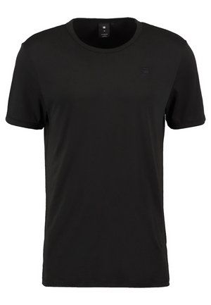 Sort T-shirt med korte ærmer lavet af glat stof. Rund hals med subtil logodetalje på venstre bryst. Standard pasform.