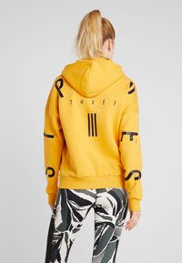 adidas Performance Felpa con zip - gold-coloured