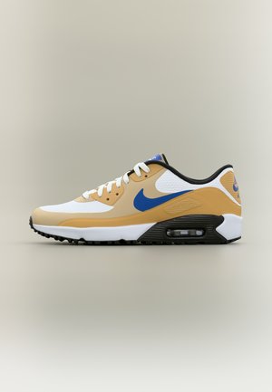 Chaussure de sport basse en blanc, beige et bleu avec une semelle à coussin d'air visible et une semelle extérieure noire, vue de profil latéral.