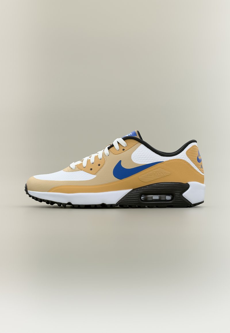 Chaussure de sport basse en blanc, beige et bleu avec une semelle à coussin d'air visible et une semelle extérieure noire, vue de profil latéral.