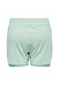 Világoszöld atlétikai rövidnadrág rugalmas derékpánttal és réteges szegéllyel, hátulról fehér háttéren bemutatva.