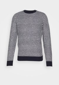 Neulepaita, jossa on kohokuvioitu kuvio laivastonsinisenä ja valkoisena, pyöreä kaula-aukko, pitkät hihat sekä resorit helmassa ja hihansuissa.