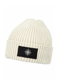 Cream-colored knitted beanie with a ribbed texture. Features a black rectangular patch displaying a compass design and directional letters.