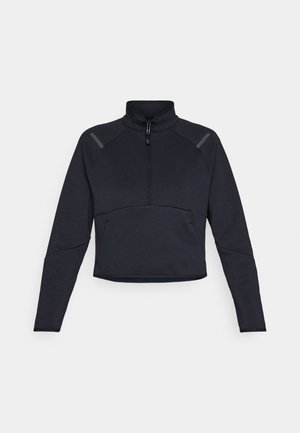 Pull-over sportif navy foncé avec un col haut, fermeture éclair et manches longues. Présente des accents de panneaux contrastants sur les épaules et un design court.