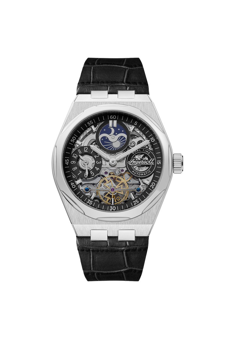 Srebrny automatyczny zegarek z czarnym paskiem ze skóry krokodyla. Posiada szkieletową tarczę, wyświetlacz podwójnego czasu oraz dekoracyjne akcenty w formie zębatek.